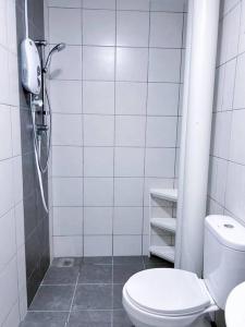 a white bathroom with a toilet and a shower at TheSun #Studio #BayanLepas #Pisa in Kampong Manggis +21 photos