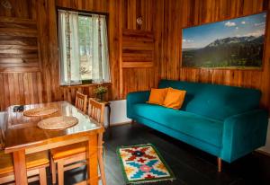 a living room with a blue couch and a table at Apartman Djokovic in Žabljak