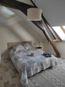 a bedroom with a bed with a blue blanket at Le Moulin Neuf in Brienon-sur-Armançon