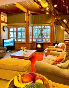 a living room with a couch and a table with fruit at Kihachikan North Nozawa Onsen in Nozawa Onsen