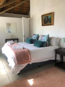a bedroom with a large white bed with pillows at Villa Jullienne - A Home Away From Home - Unit 9 in Nelspruit