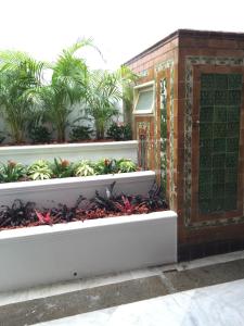 a facade of a building with plants at Heeren Palm Suites in Melaka