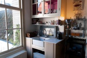 a kitchen with a sink and a window at B&B Herengracht 21 in Amsterdam +8 photos