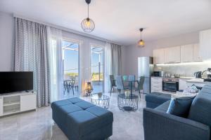 un soggiorno con divano blu e una cucina di Sun Angelo luxury apartment in Paradise 1 ad Arménoi