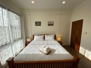 ein Schlafzimmer mit einem Bett und einem Handtuch darauf in der Unterkunft 1 min walk to BTS, 3 Bed 3 Bath, Entire House in Bangkok