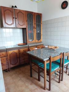 a kitchen with a table with a cat laying on it at appartamento a 700 mt. dal mare. in Terracina