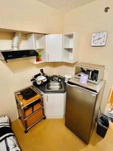 a small kitchen with a sink and a refrigerator at * * G Best value for the price! in Iloilo City