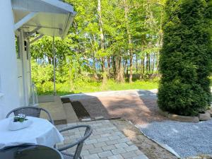 a patio with a table and chairs and trees at Gränna View in Gränna