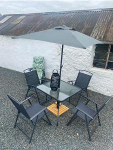a table with two chairs and an umbrella at Big Anthony’s in Greencastle