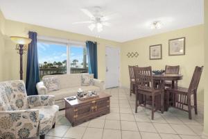 a living room with a couch and a table at Summer House West B103 in Gulf Shores