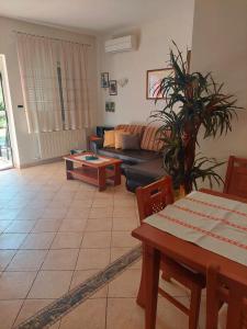 a living room with a couch and a table at Apartments Mogorović in Mošćenička Draga