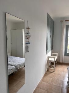 a mirror in a room with a table and a chair at Apartamentos Calan Blanes Park CB APM 2142 ,nº207 in Cala en Blanes
