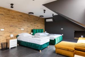 two beds in a room with a staircase at Hostel Dzika Kaczka 