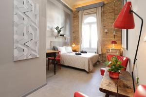 a hotel room with a bed and a table and chairs at BudapeStayz - Raday Rooms in Budapest