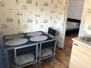 a kitchen with a table and chairs in a room at Apartamenti Elkonju 3 in Liepāja