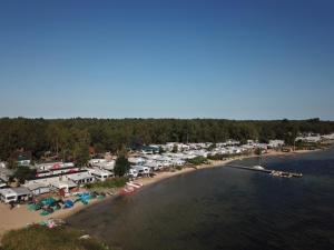 an aerial view of a beach with a bunch of tents at domek kempingowy in Chałupy