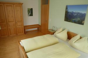 a room with two beds in a room with a door at Apartment Neuhauser in Kramsach