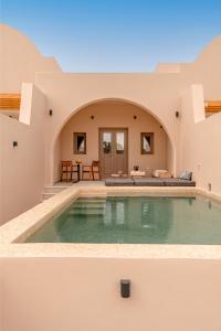 a villa with a swimming pool in the desert at Living Moments Villa Amersa in Mesaria
