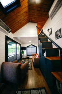 a living room with a staircase in a house at Cappatiny House in Goreme