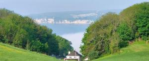 a house on the side of a hill near a lake at Seaton, Devon, two bed apartment, just off the sea front. in Seaton