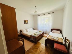 a small room with two beds and a window at Holiday Home Vesna in Budva