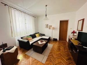 a living room with a couch and a television at Holiday Home Vesna in Budva