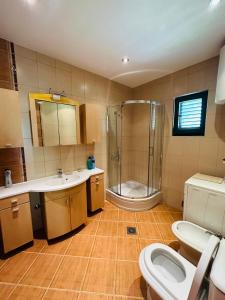 a bathroom with a shower and a sink and a toilet at Holiday Home Vesna in Budva +24 photos
