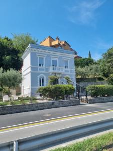 a white building on the side of a road at Villa Maria in Koper