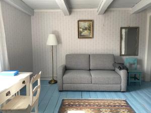 a living room with a couch and a table at Krepelin Apartments in Kristiinankaupunki