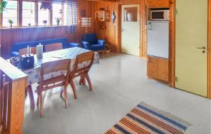 a kitchen and dining room with a table and a refrigerator at Lovely Apartment In lvdalen With Kitchen in Älvdalen