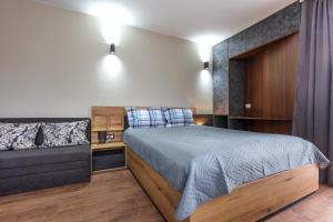 a bedroom with a bed and a couch at View apartment #1 in Bansko