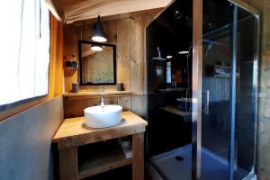 a bathroom with a sink and a shower at Silver Coast Glamping luxury lodge in Alcobaça