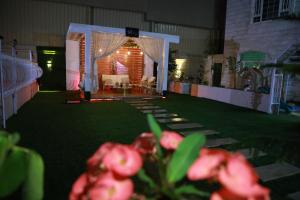 a room with a tent and a lawn with flowers at Happy Day هابي دي 