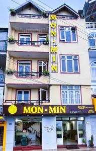 a building with a mom min sign in front of it at Mon-Min Hotel in Da Lat