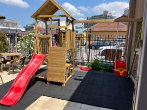 a wooden playground with a slide and a slideintend at Pensiunea Ana Maria in Baile Felix