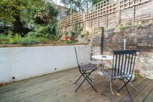 - une terrasse avec 2 chaises et une table dans l'établissement Spacious 2 bedroom Apartment in Camden, à Londres