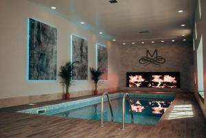 a swimming pool with a fireplace in a house at Manor House Hotel in Bishop Auckland