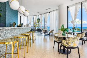 a bar with chairs and tables and windows at Tizate Residences #136 in Cruz de Huanacaxtle