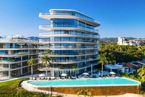 a large building with a swimming pool and a resort at Tizate Residences #136 in Cruz de Huanacaxtle