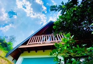 a building with a balcony on top of it at Tea cabin by Hoyts in Deraniyagala