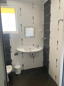 a bathroom with a sink and a toilet at Safo Apartments and Rooms in Sozopol