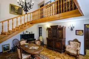 a living room with a staircase and a table and chairs at Vintage Villa Saguramo 