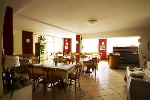 a restaurant with tables and chairs in a room at Albergo Lario in Gera Lario