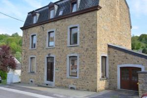 un bâtiment en briques avec un toit noir dans l'établissement Granny Cottage., à Marchin