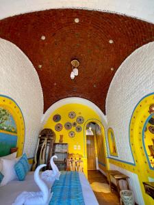 a bedroom with swans on a bed in a room at Kato Dool Wellness Resort in Aswan