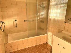 a bathroom with a shower and a tub and a sink at Easy Self Check-in accomodation in Springvale +21 photos