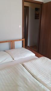 two beds sitting next to each other in a room at Apart Magda 2 in Rewal