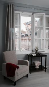 
a living room filled with furniture and a window at Fresh* Sheets Kathedral Dubrovnik in Dubrovnik

