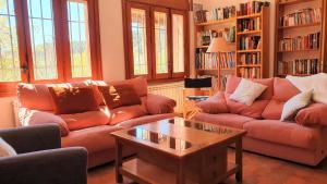 a living room with two couches and a coffee table at Casa El Prao in Arenas de San Pedro