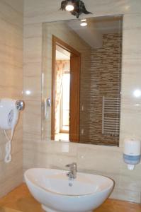 a bathroom with a sink and a mirror at Montenero Resort&Spa in Czarna Góra